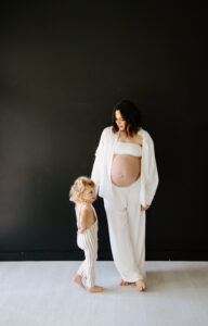 Austin Maternity Photographer, pregnant woman holding hand of toddler child
