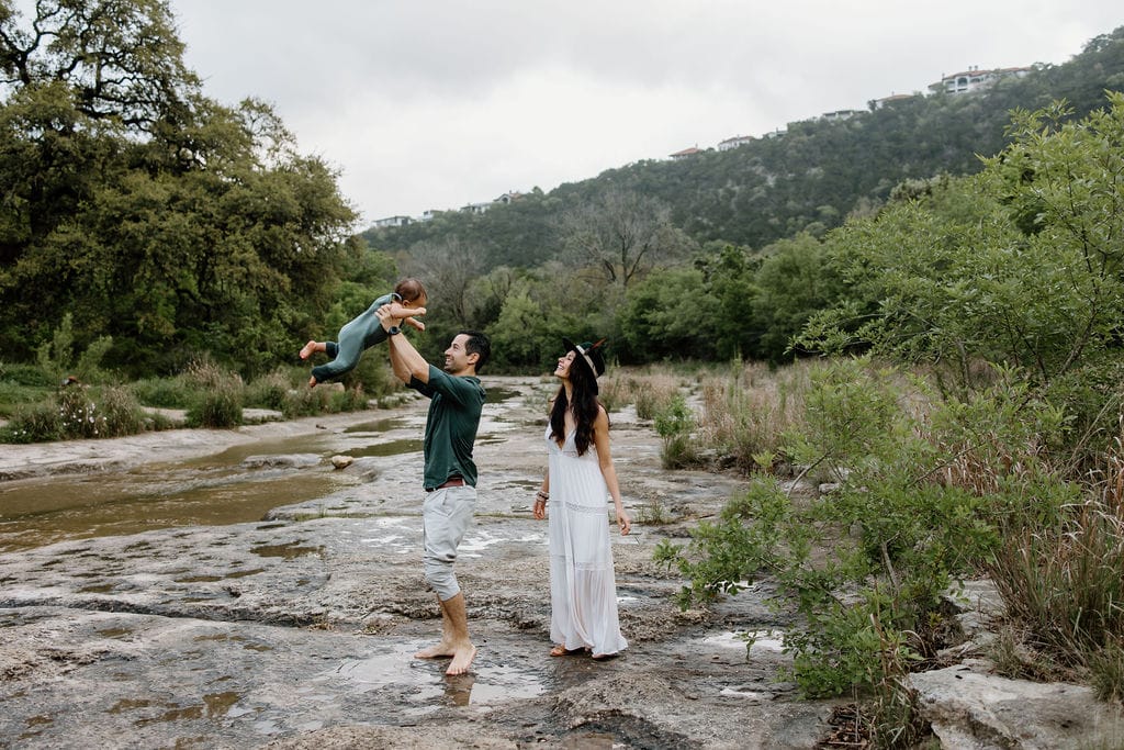 Family in Austin, Texas plays in Bull Creek during lifestyle photos