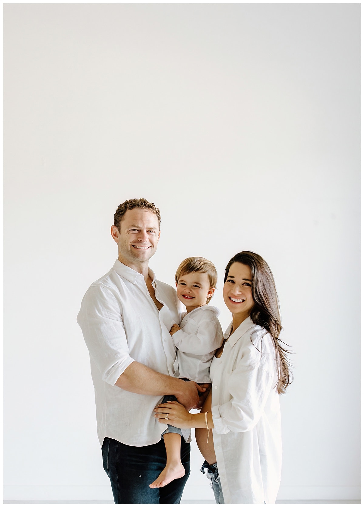 Dad and mom smile with young boy for Austin Motherhood Photographer