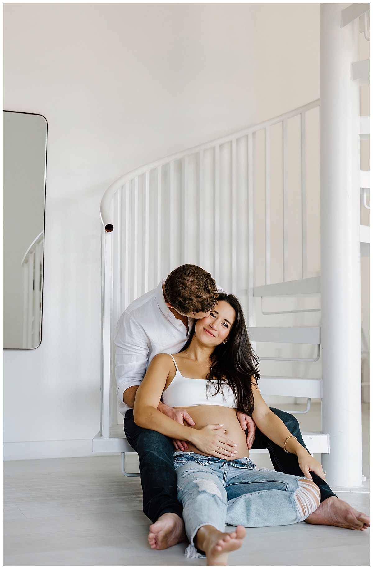 Mom and dad share a kiss for Studio Maternity Photos