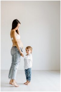 Mother and son play with one another for Studio Maternity Photos