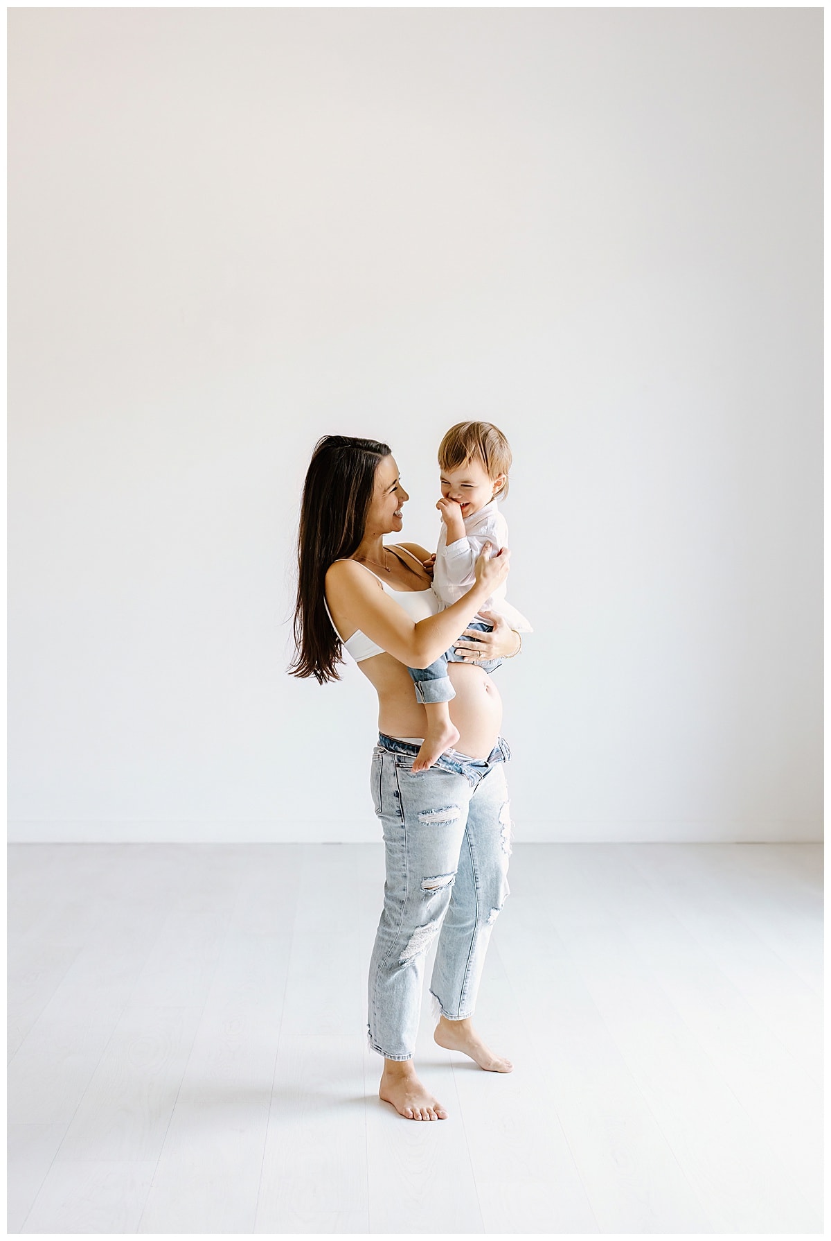 Son smiles with mom for Studio Maternity Photos