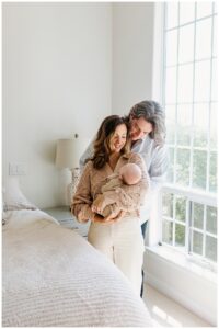 Mom and dad smile at newborn baby for Austin Motherhood Photographer