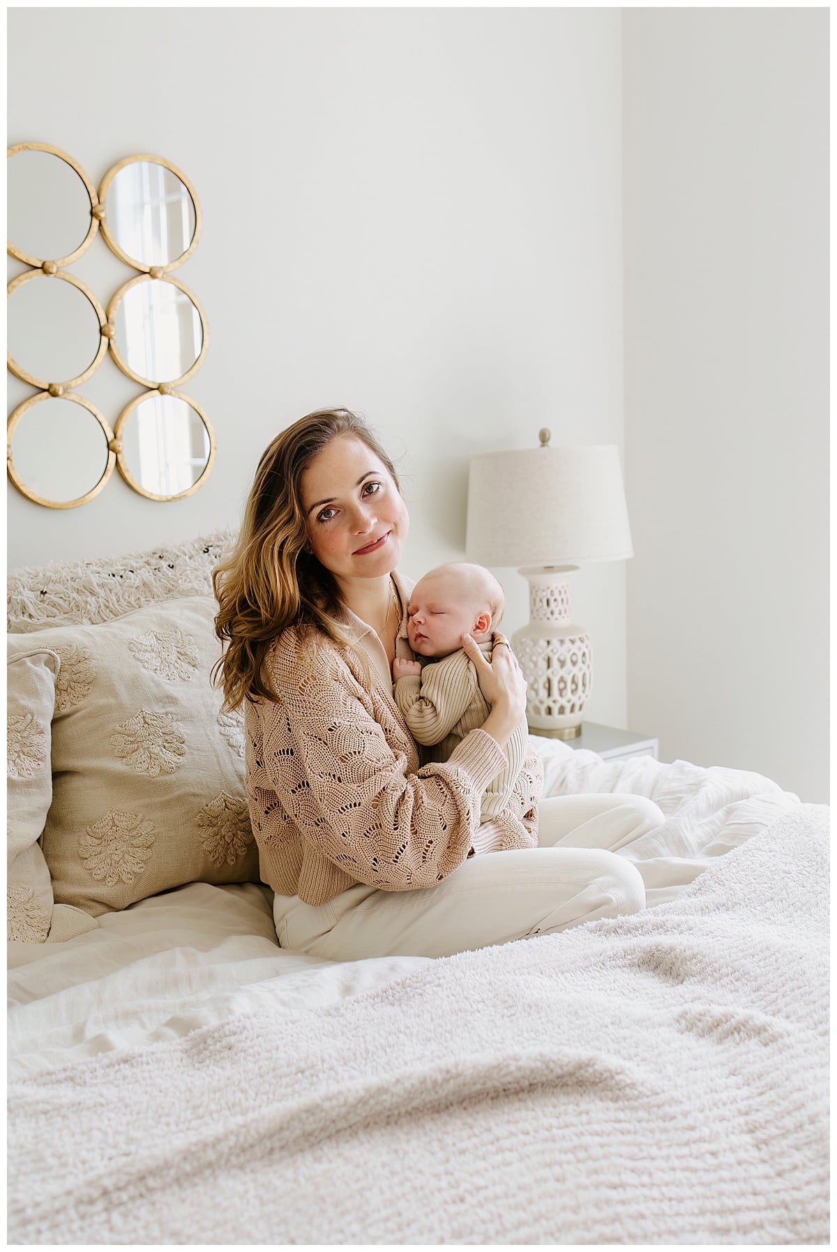 Mother holds baby close on bed for Austin Motherhood Photographer