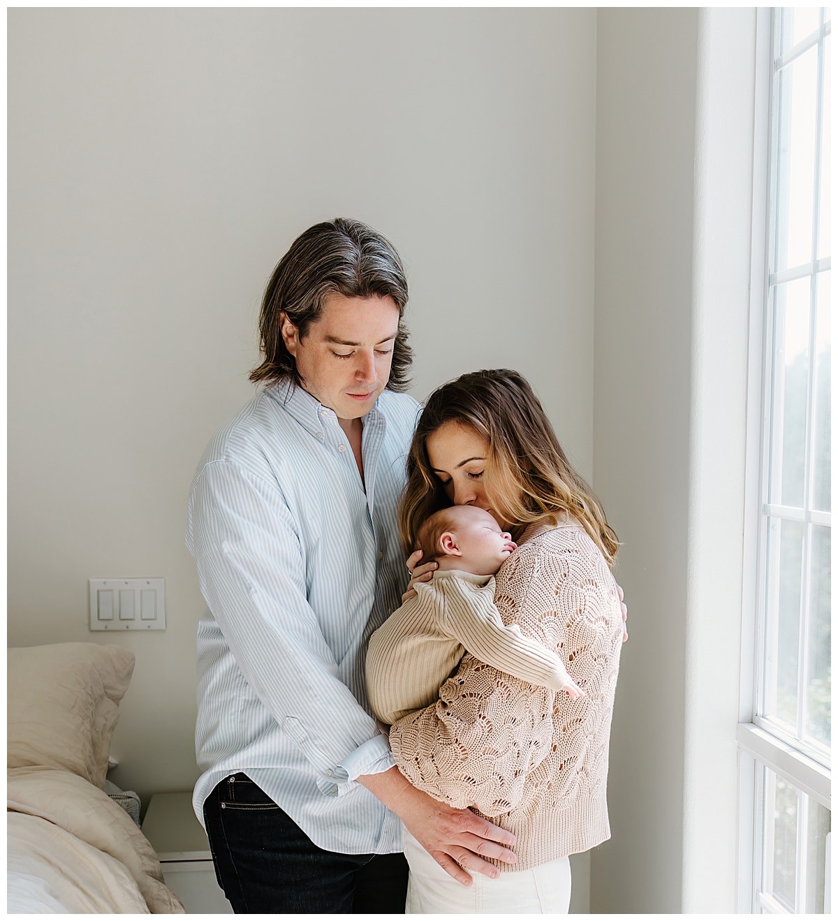 Mom and dad cuddle newborn close for Austin Motherhood Photographer