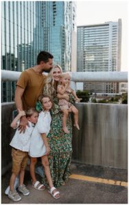 Dad kisses mom on her head for Downtown Austin Rooftop Family Session