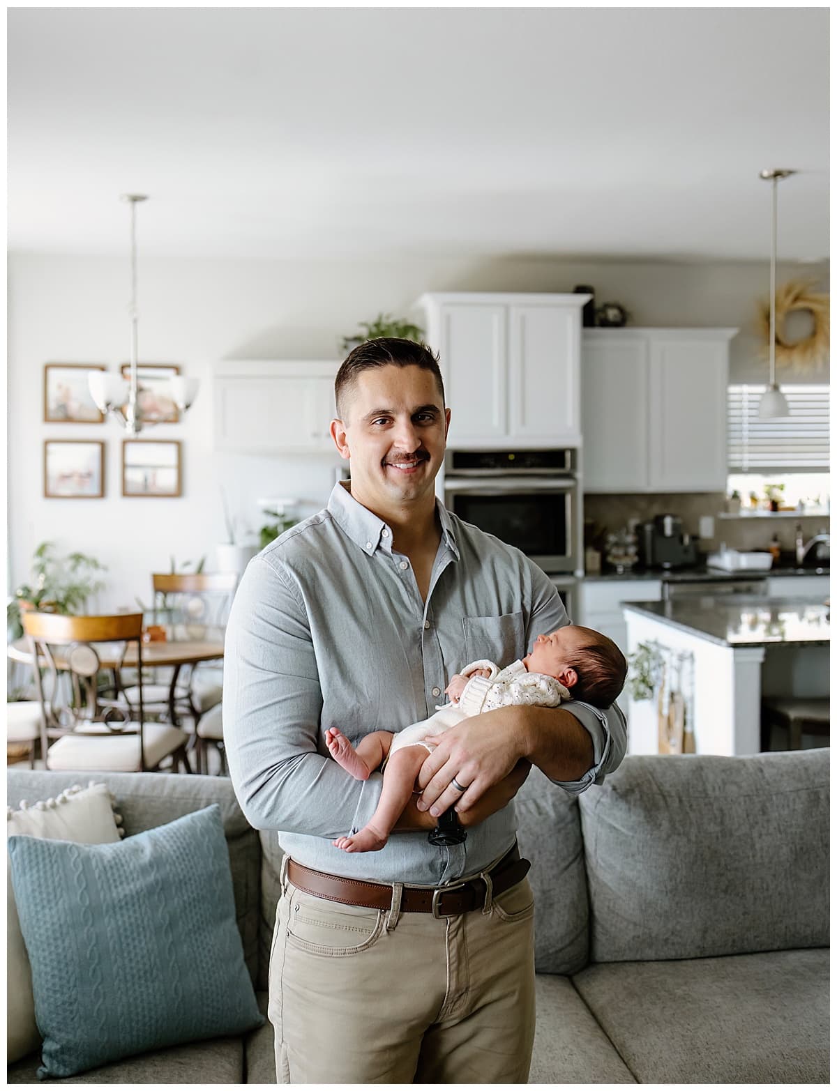 Dad holds baby for their In-Home Newborn Storytelling Session