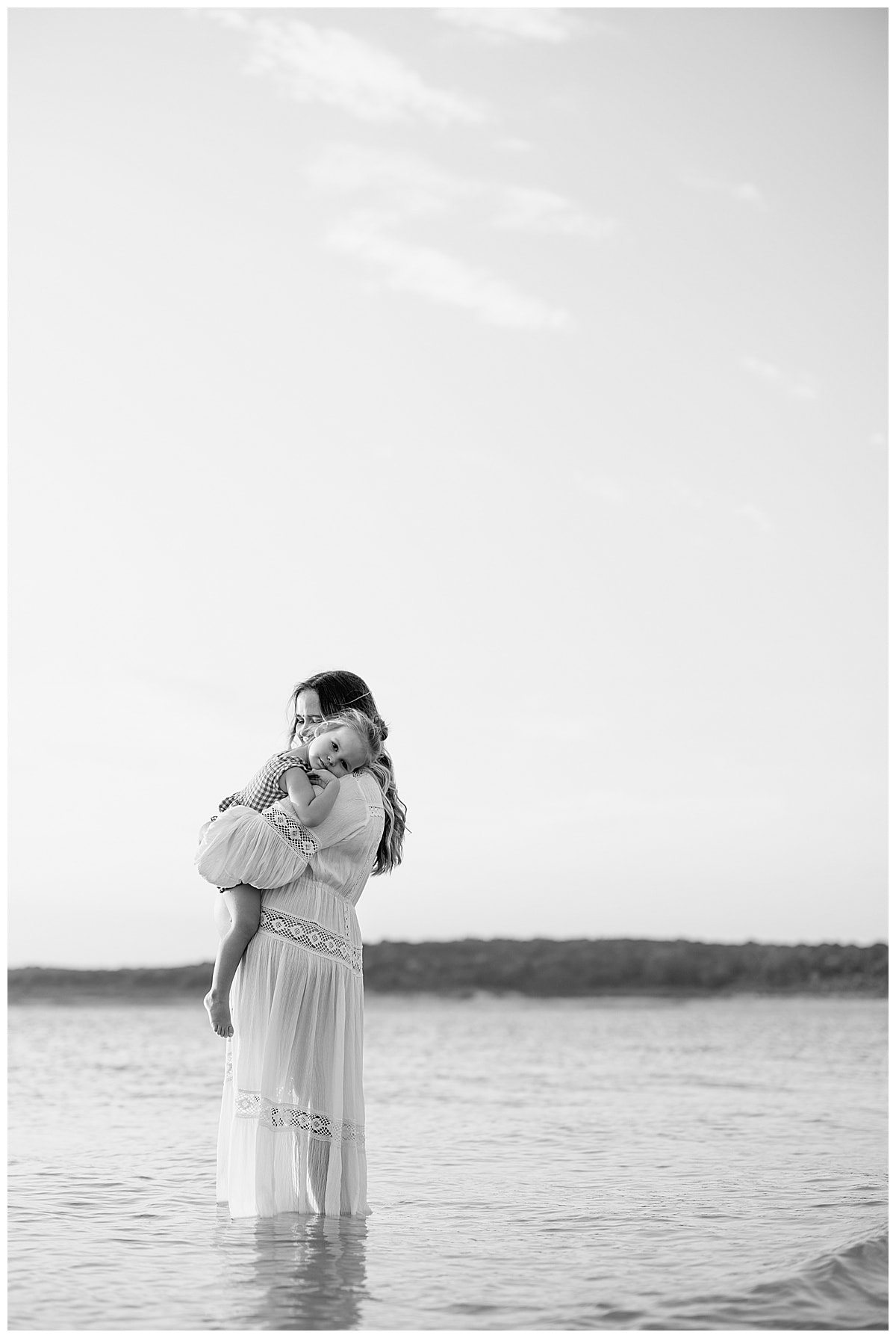 Mom and daughter share a hug for Sandy Beach Maternity Session
