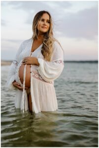 Woman holds pregnant belly for Our Adventuring Souls Photography
