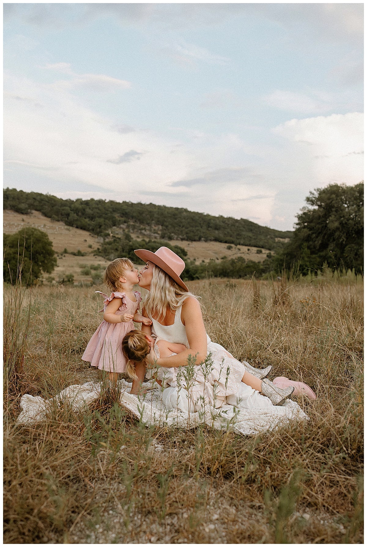 Mom shares a kiss with her daughter during their Outdoor Motherhood Story 