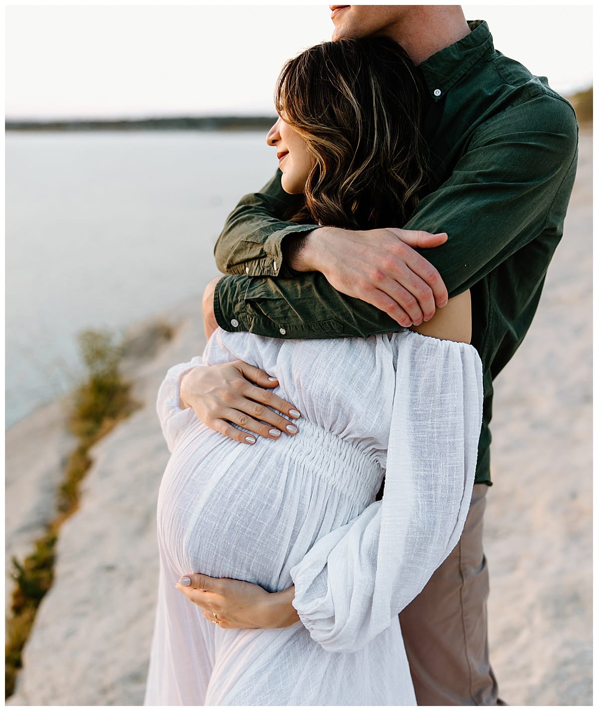 Man wraps arms around woman during her outdoor maternity session