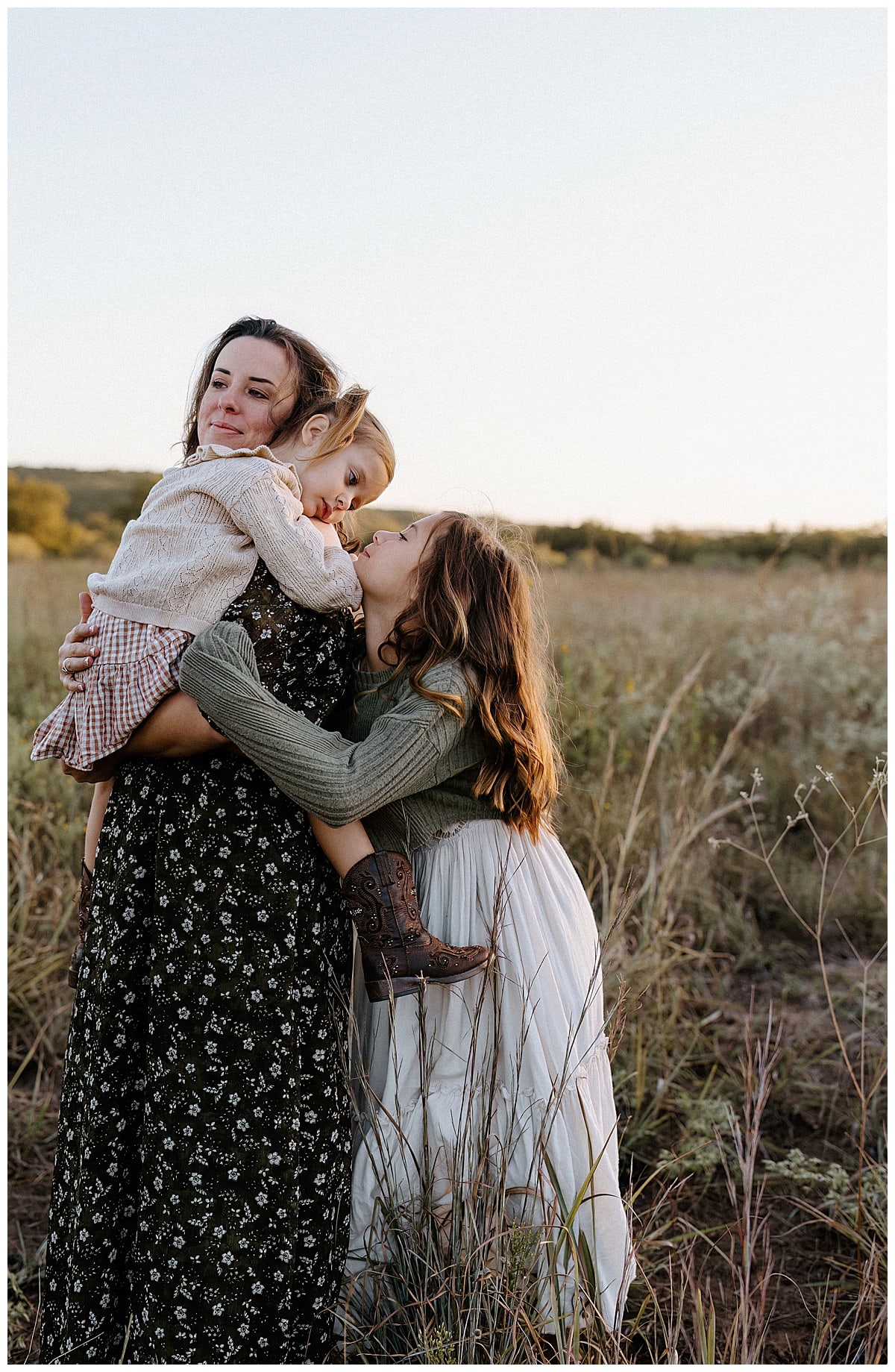 Young girls cuddle and hug their mom during their Sunrise Family Photos