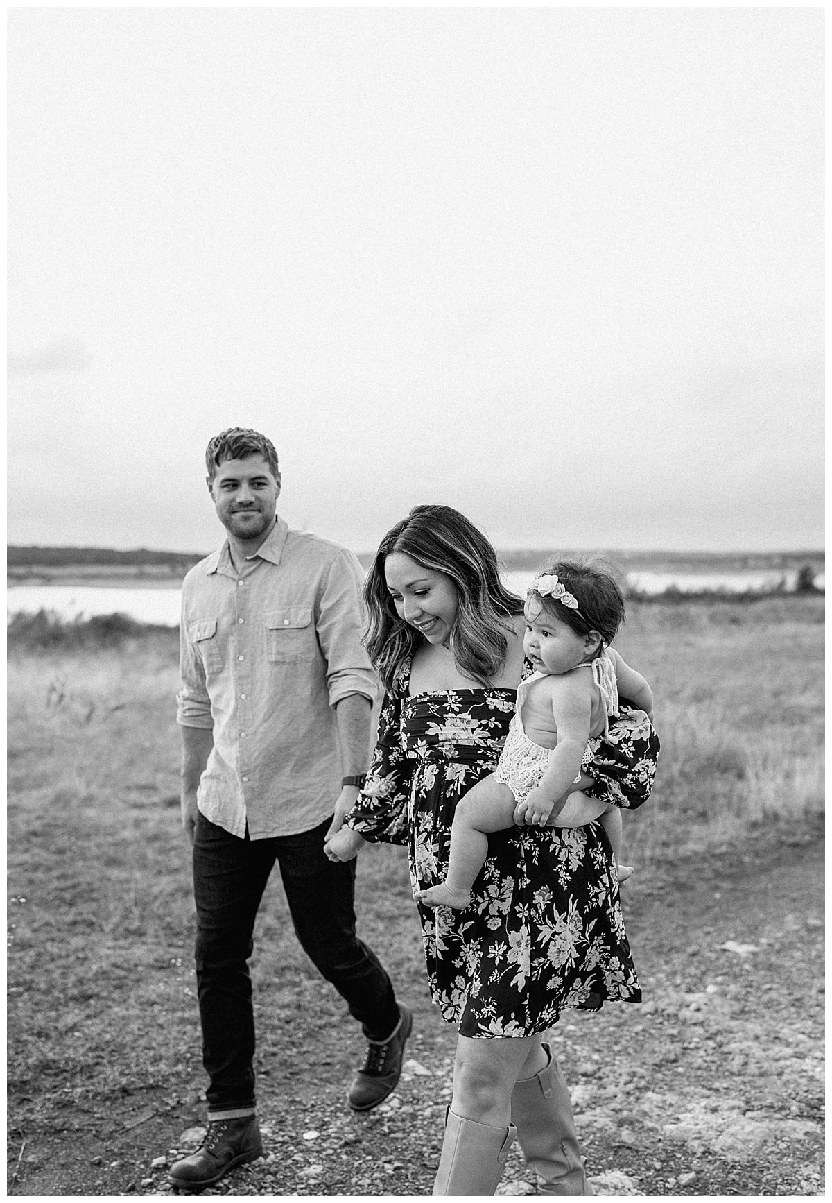 Parents walk with their baby during First Birthday Family Photos 
