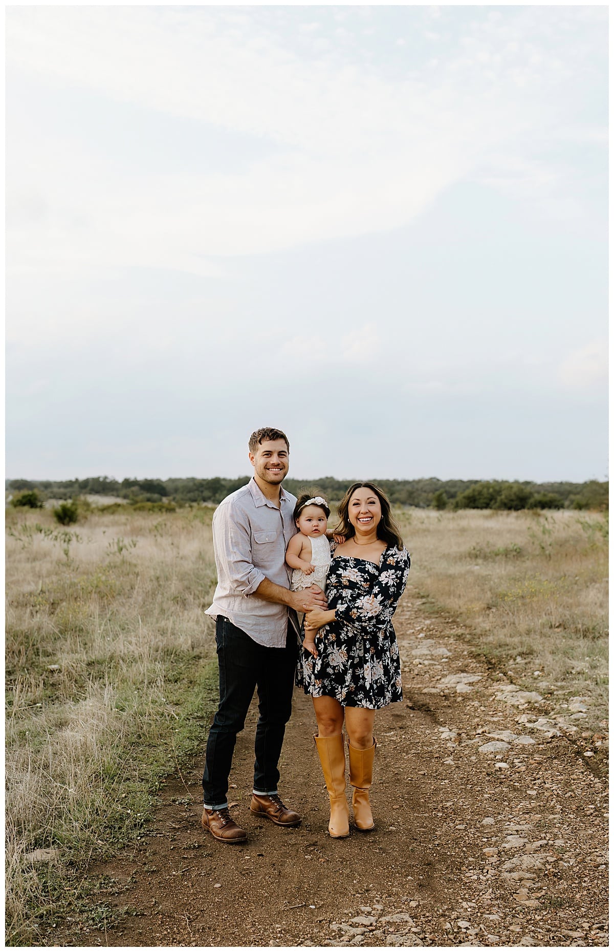 Parents smile big while holding their baby for Austin Motherhood Photographer