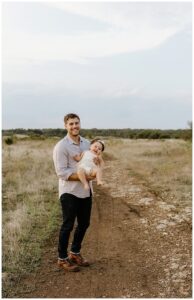 Dad holds baby and smiles big for Austin Motherhood Photographer
