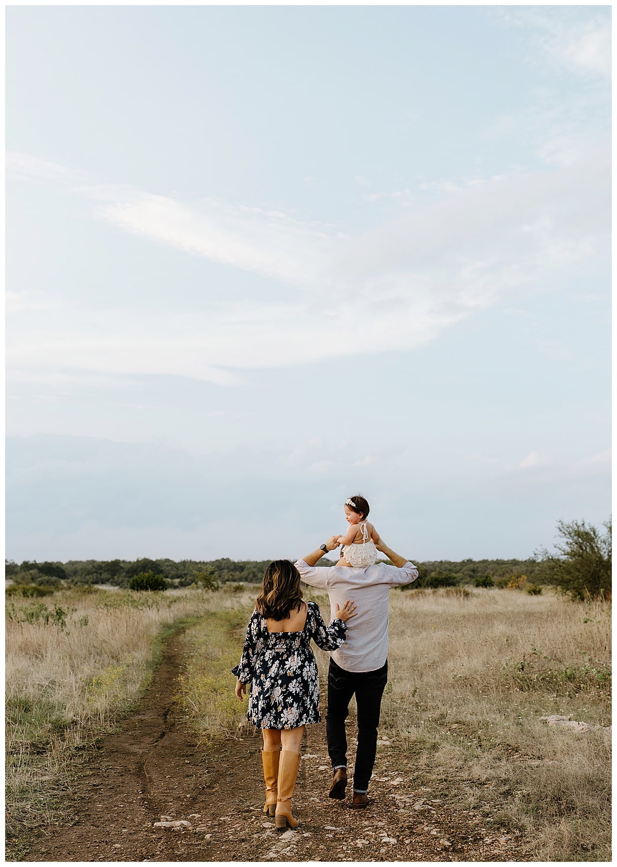 Parents hold baby and walk together for Austin Motherhood Photographer