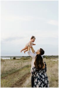 Mom and dad toss baby in the air for First Birthday Family Photos