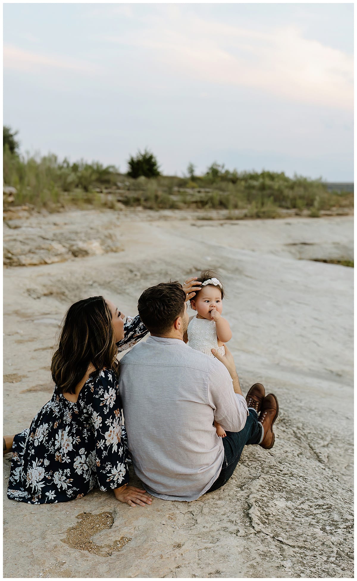 Mom and dad smile at baby girl for First Birthday Family Photos 