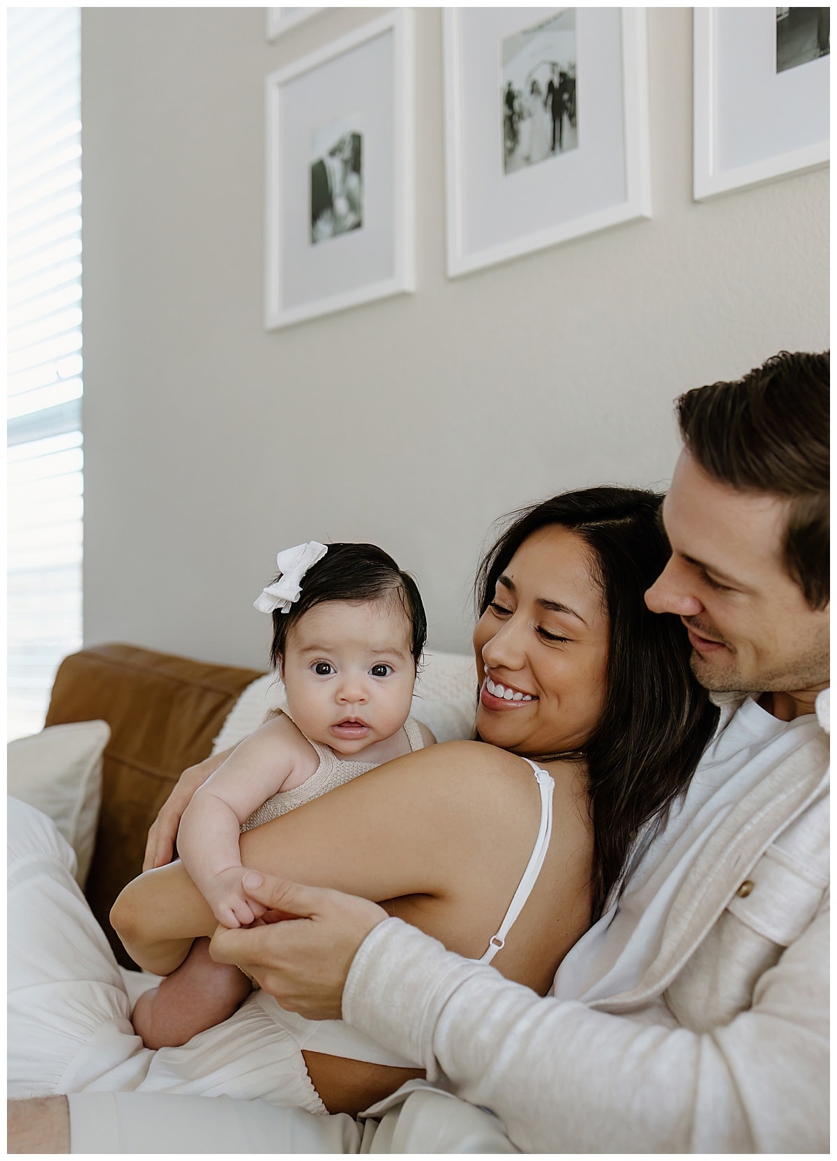 Parents smile at their baby understanding the importance of being able to Document Your Newborn