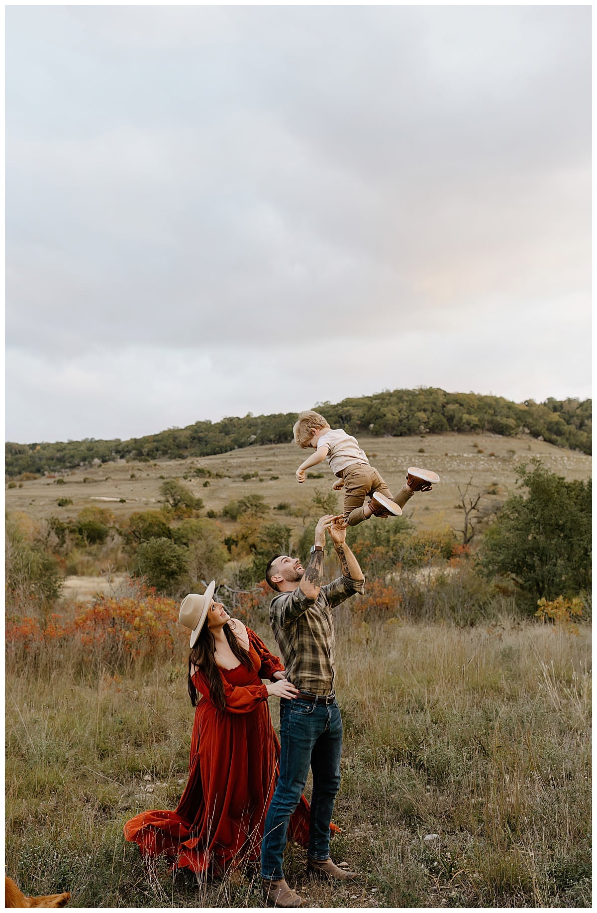Parents throw their son in the air after their Baby Announcement