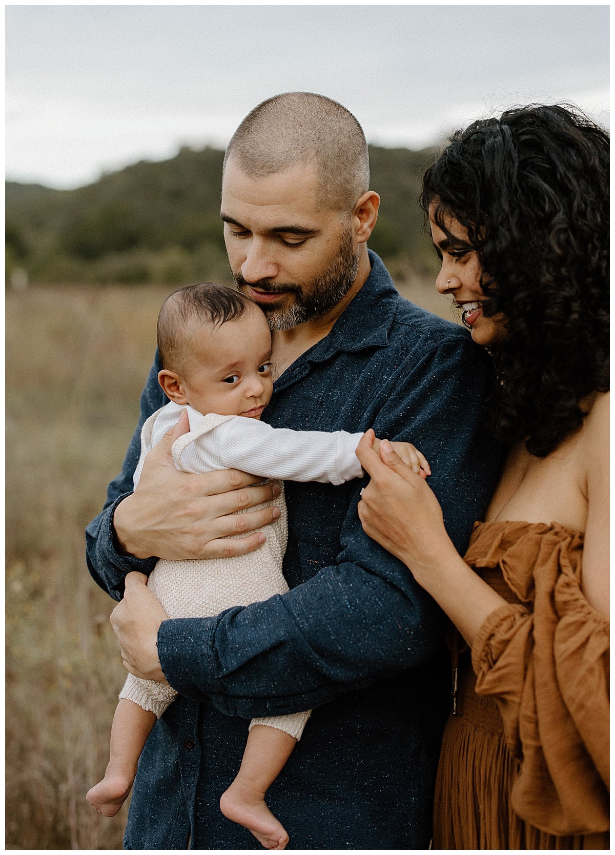 Parents hold their baby close for Lifestyle Family Photos 