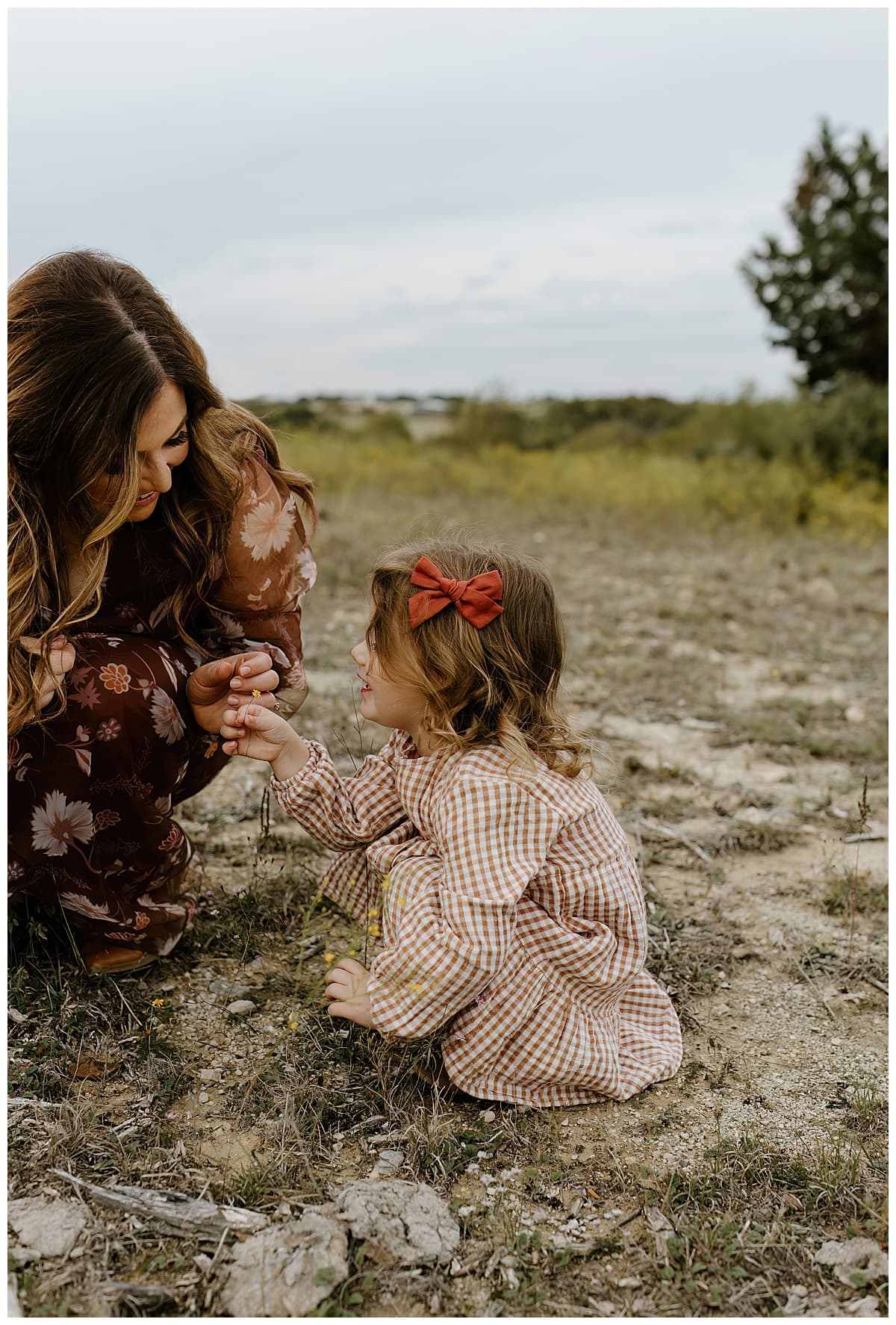 Mom and young daughter look at a leaf together for Our Adventuring Souls Photography
