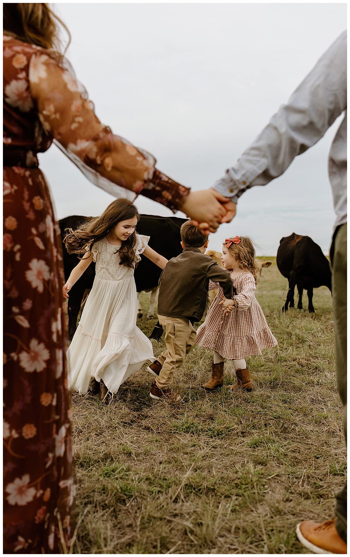 Young kids hold hands and spin together for Our Adventuring Souls Photography