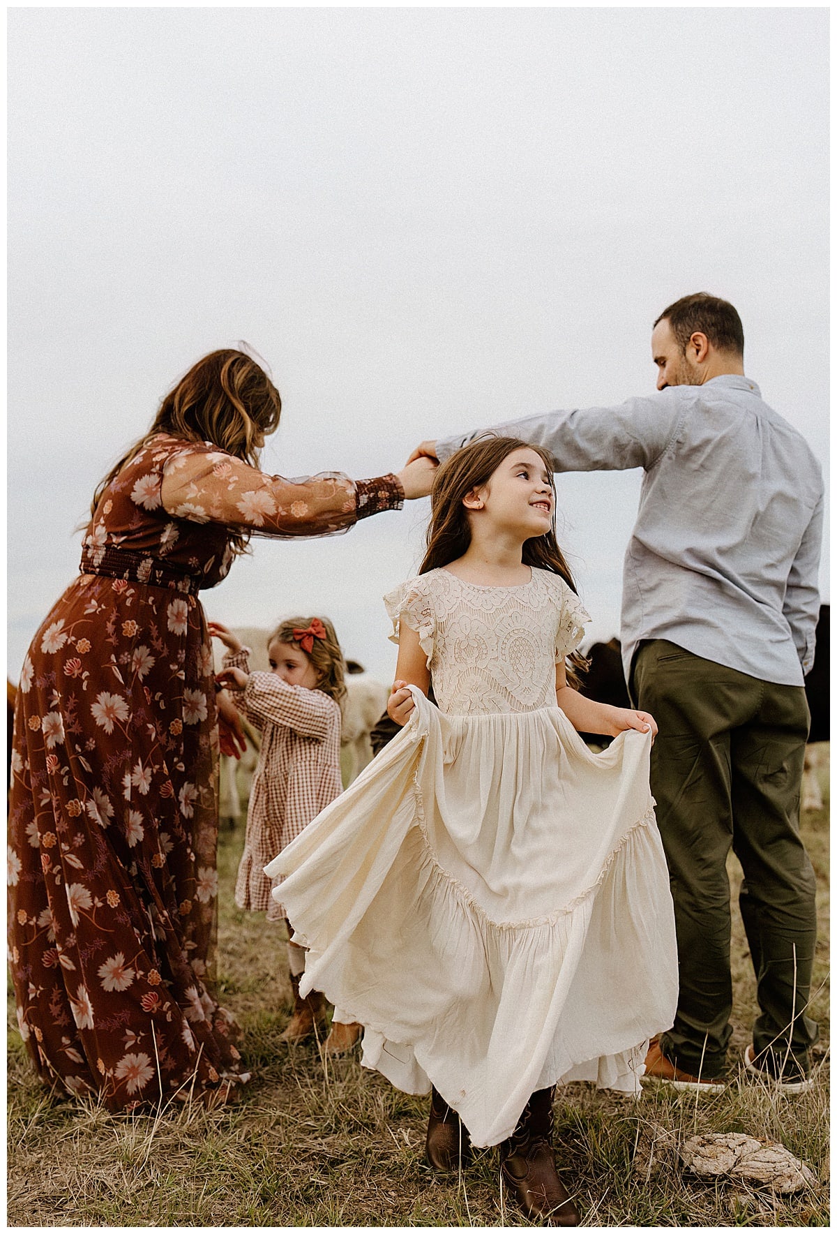 Young girl dances with her dress during their Family Adventure Session