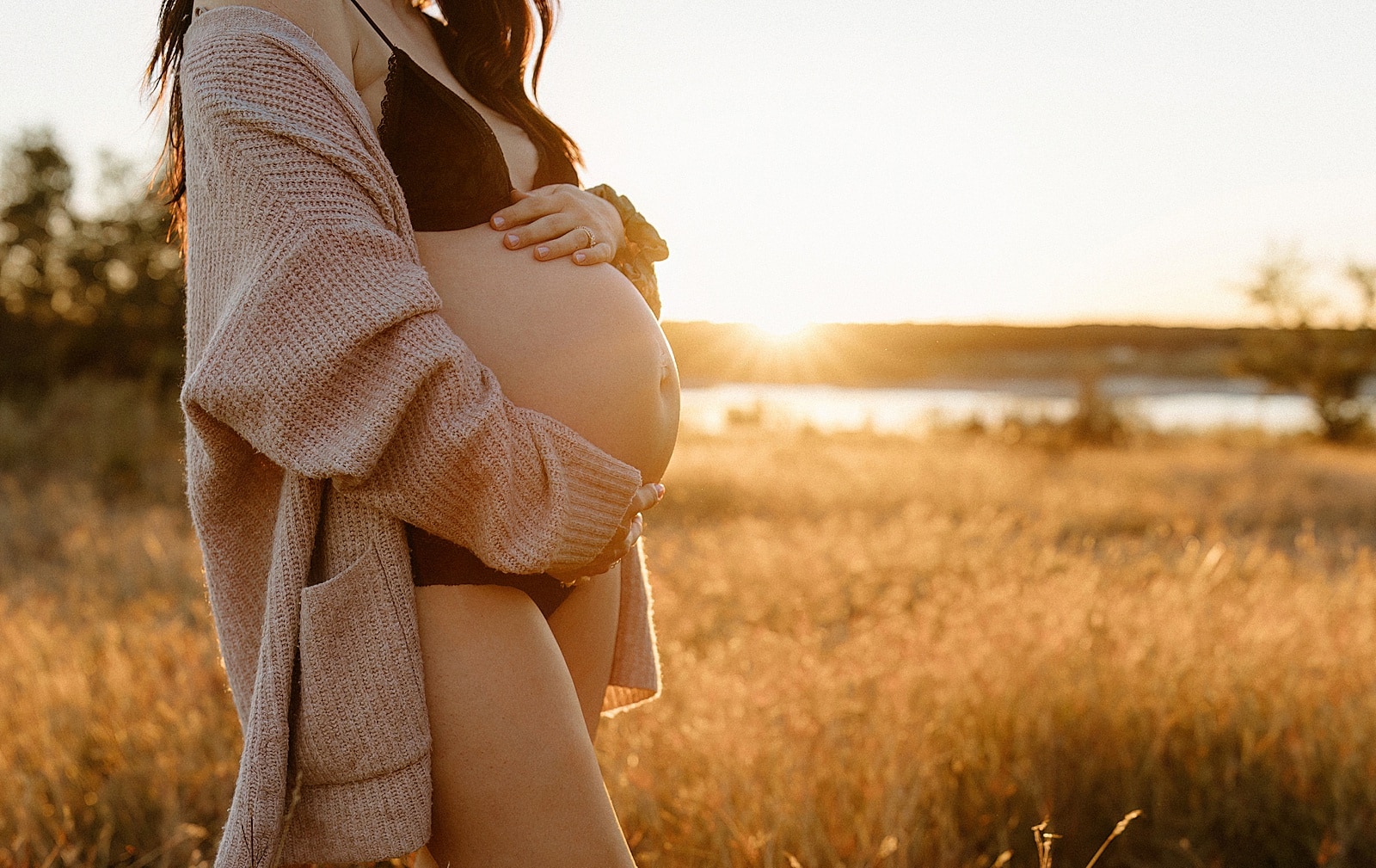 Mom holds hands on pregnant belly for Our Adventuring Souls Photography