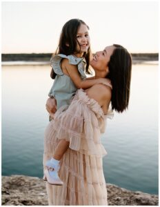 Mom smiles at daughter for outdoor lifestyle photoshoot