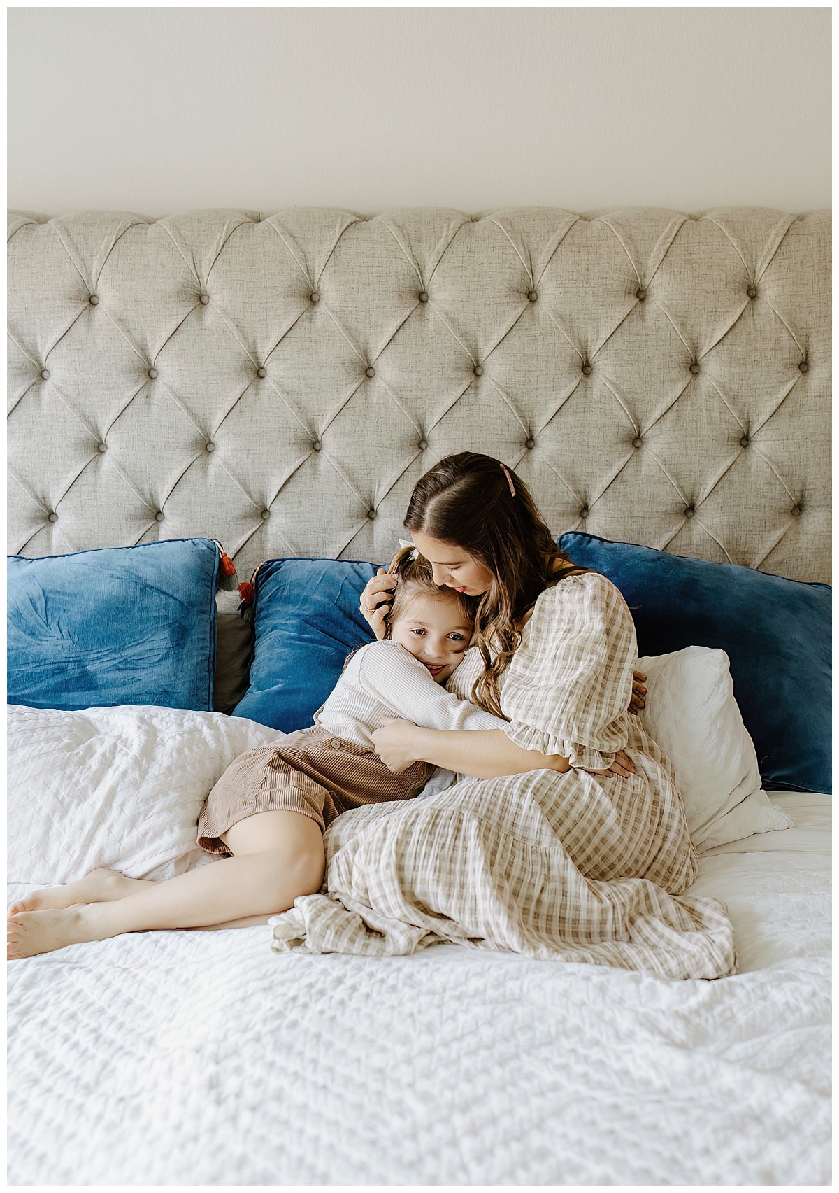 Mom cuddle young girl on the bed for Our Adventuring Souls Photography