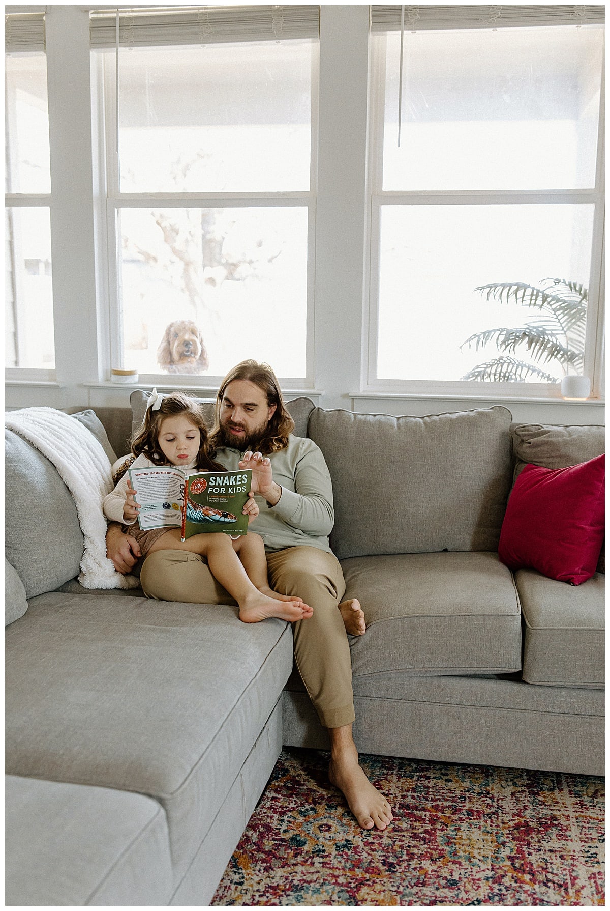Dad and daughter sit together on the couch for Our Adventuring Souls Photography