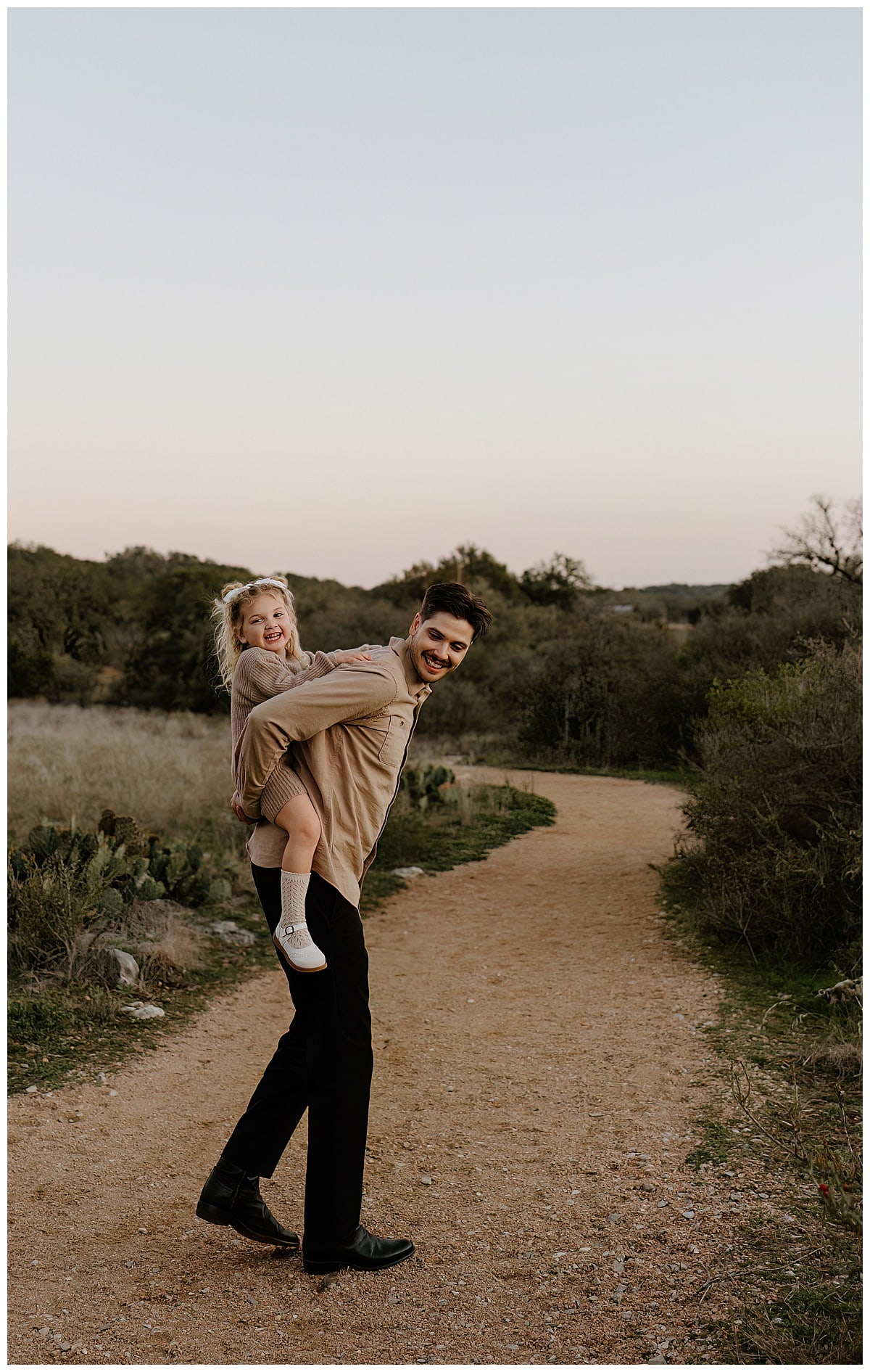 Dad gives daughter a piggy back ride for Austin Lifestyle Photographer