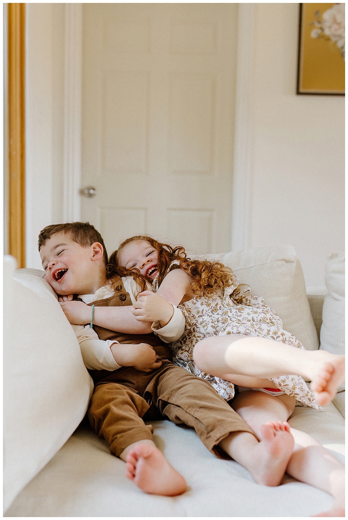 Kids laugh together on the couch for Austin Motherhood Photographer