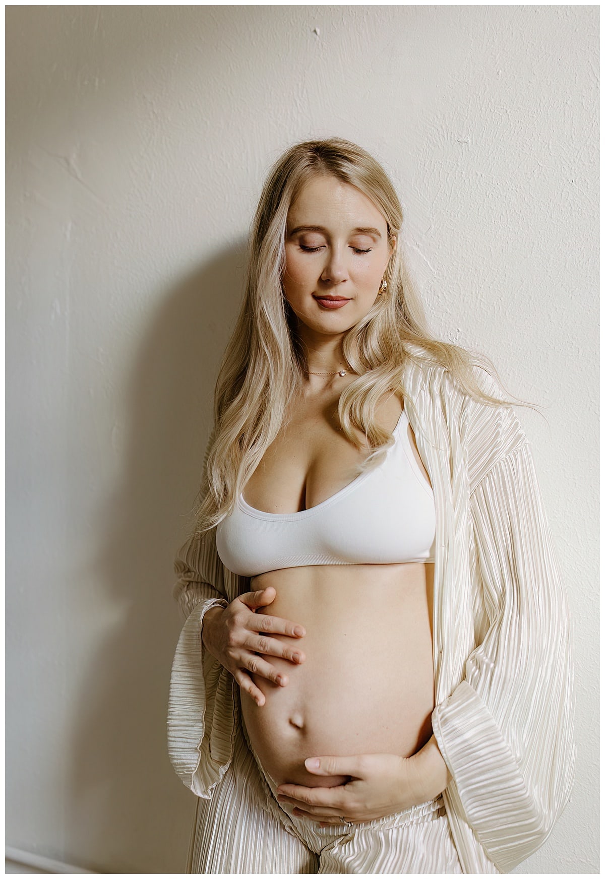 Female embraces her pregnant belly for Austin Motherhood Photographer