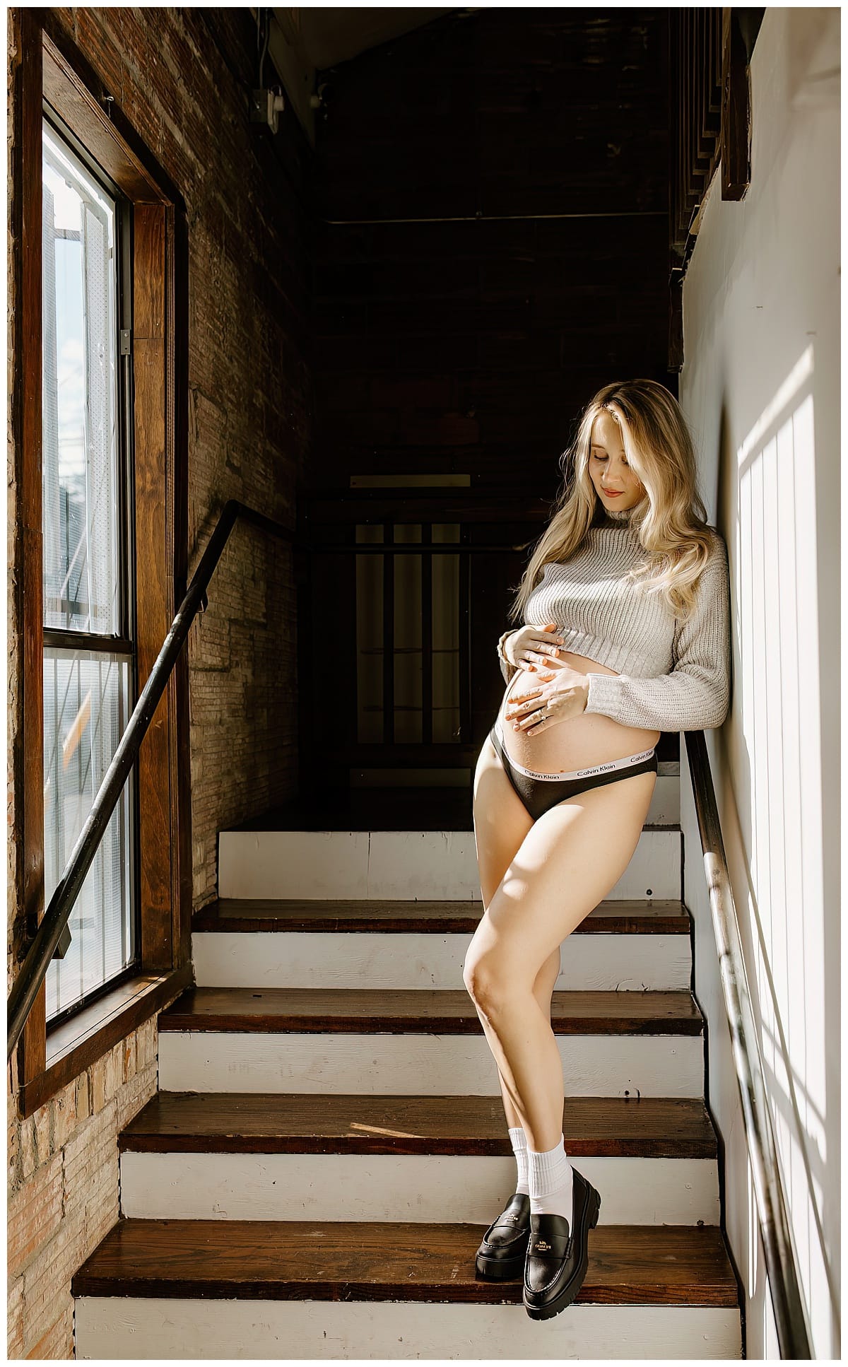 Adult leans onto stairs for studio maternity session
