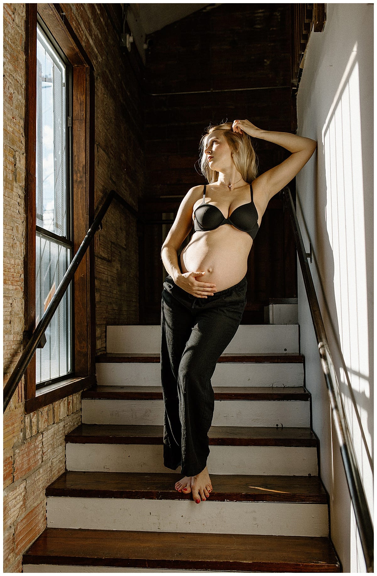 Woman holds her pregnant belly for Our Adventuring Souls Photography