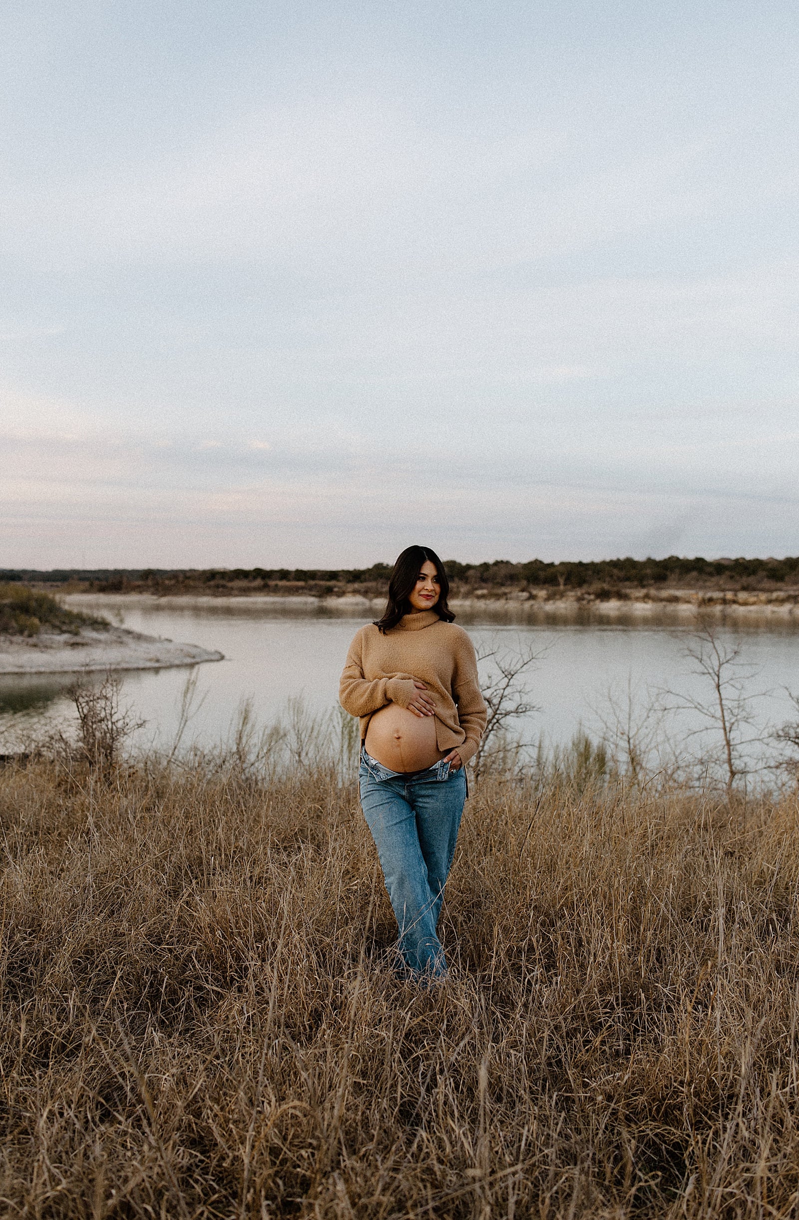 Mom holds onto her baby bump showing off the perfect Maternity Session Outfit Inspiration